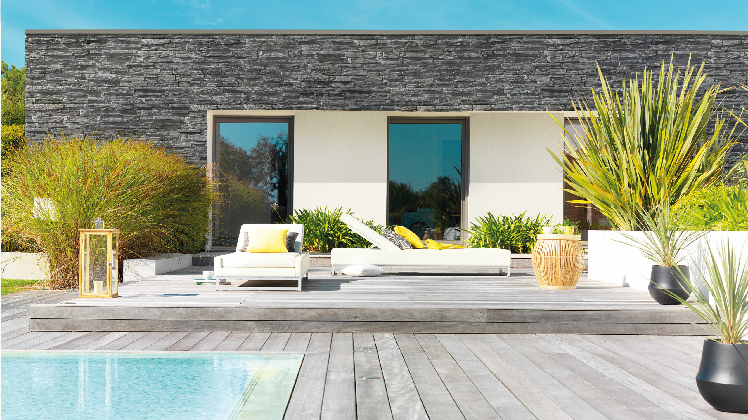 Parement de pierre Collection Yosemite Orsol en schiste anthracite nervuré autour d’une piscine contemporaine